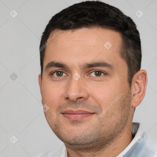 Joyful white young-adult male with short  black hair and brown eyes