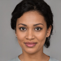 Joyful black young-adult female with medium  brown hair and brown eyes