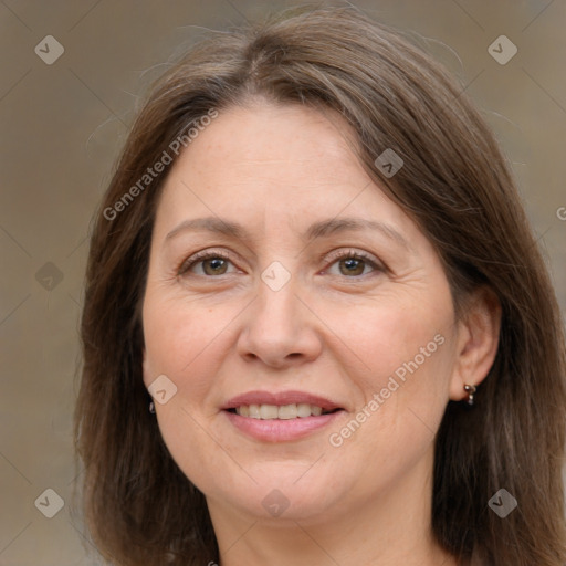 Joyful white adult female with long  brown hair and brown eyes