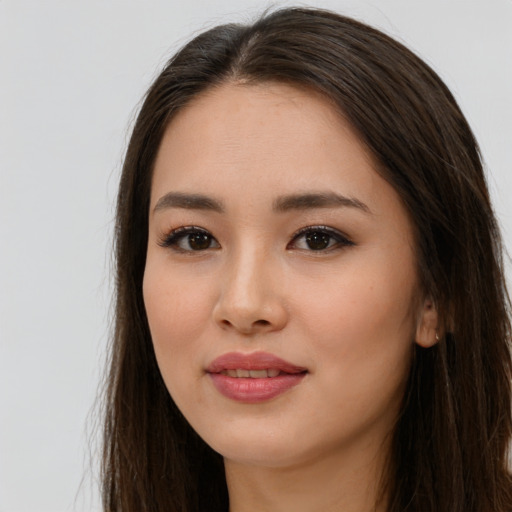 Joyful asian young-adult female with long  brown hair and brown eyes