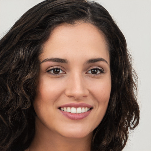 Joyful white young-adult female with long  brown hair and brown eyes