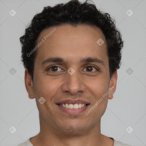 Joyful latino young-adult male with short  brown hair and brown eyes