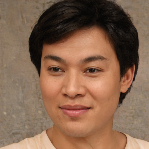 Joyful asian young-adult male with short  brown hair and brown eyes