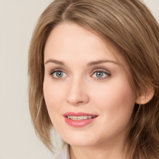 Joyful white young-adult female with long  brown hair and green eyes