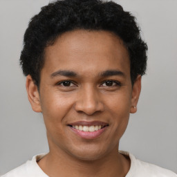 Joyful latino young-adult male with short  brown hair and brown eyes