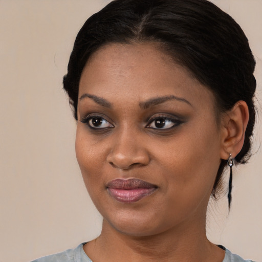 Joyful black young-adult female with medium  brown hair and brown eyes