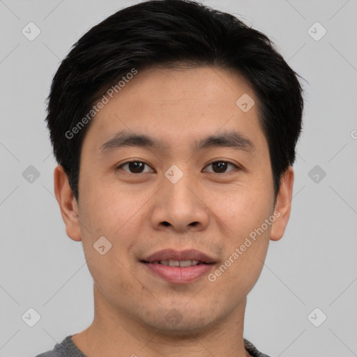 Joyful asian young-adult male with short  brown hair and brown eyes