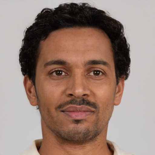 Neutral latino adult male with short  brown hair and brown eyes