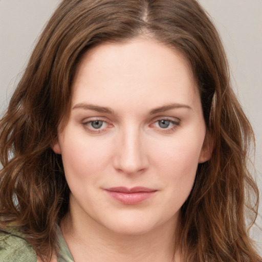 Joyful white young-adult female with long  brown hair and blue eyes