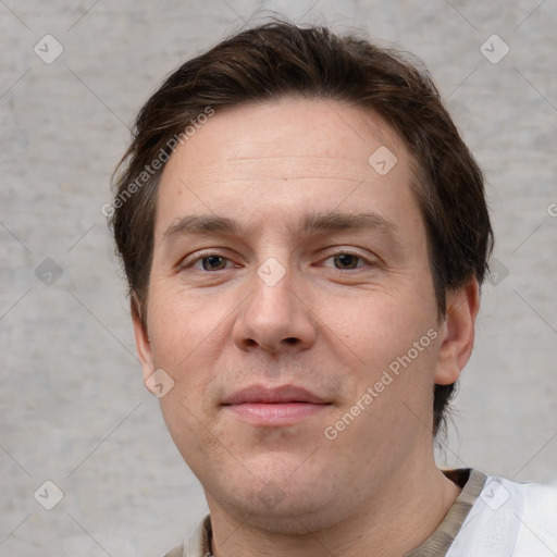 Joyful white adult male with short  brown hair and grey eyes