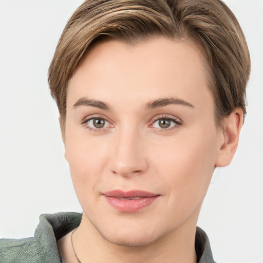 Joyful white young-adult female with short  brown hair and grey eyes