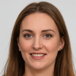 Joyful white adult female with long  brown hair and grey eyes