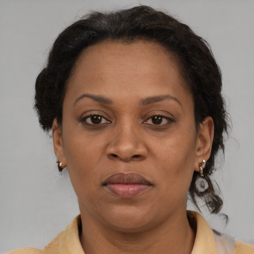 Joyful black adult female with short  brown hair and brown eyes