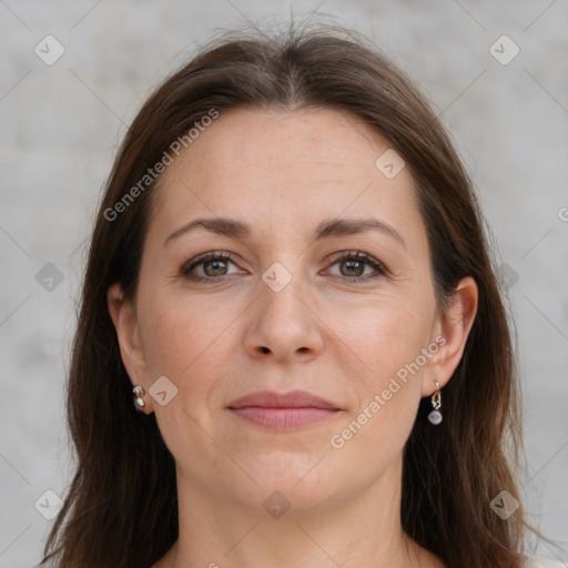 Joyful white adult female with long  brown hair and grey eyes