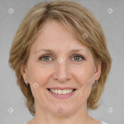 Joyful white adult female with medium  brown hair and blue eyes