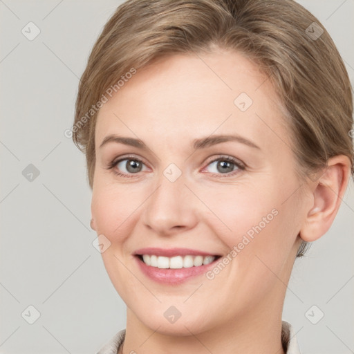 Joyful white young-adult female with short  brown hair and grey eyes