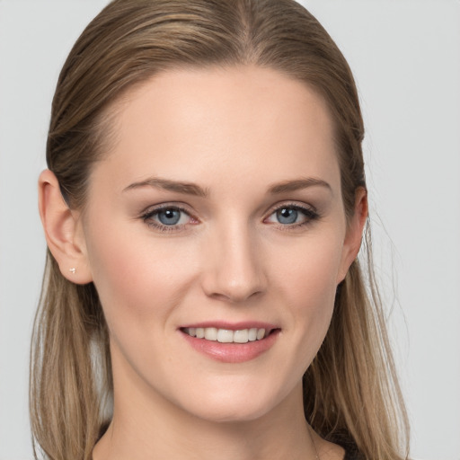 Joyful white young-adult female with long  brown hair and blue eyes