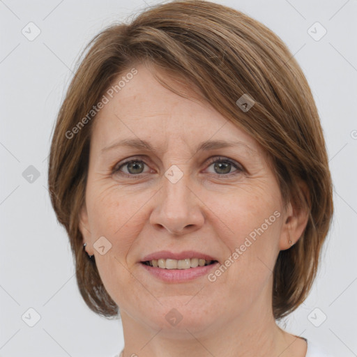 Joyful white adult female with medium  brown hair and grey eyes