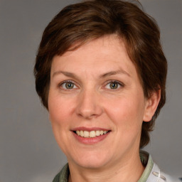 Joyful white adult female with medium  brown hair and grey eyes