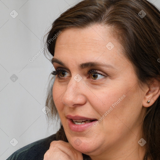 Joyful white adult female with medium  brown hair and brown eyes