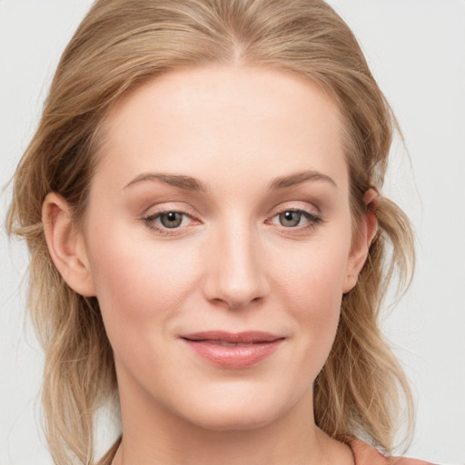 Joyful white young-adult female with medium  brown hair and blue eyes