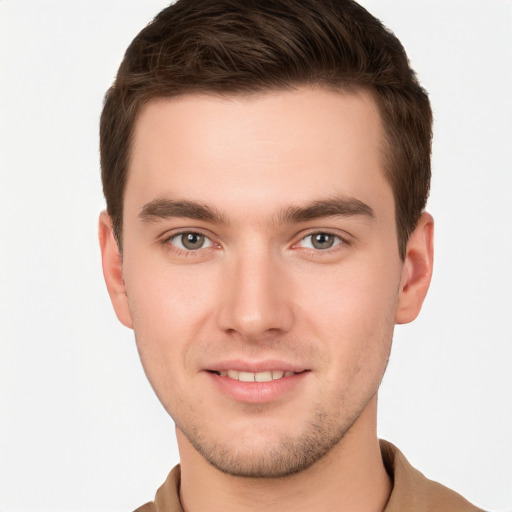 Joyful white young-adult male with short  brown hair and grey eyes