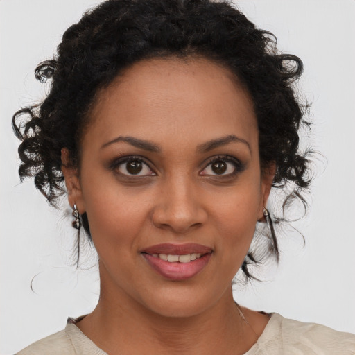 Joyful black young-adult female with medium  brown hair and brown eyes