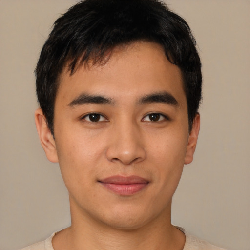 Joyful asian young-adult male with short  brown hair and brown eyes