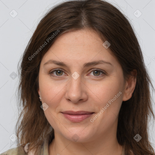 Joyful white adult female with long  brown hair and grey eyes