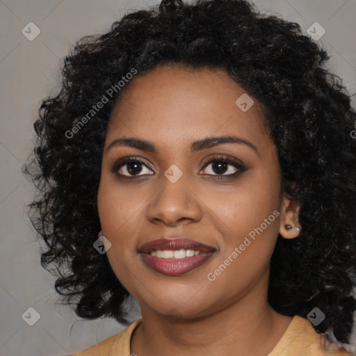 Joyful black young-adult female with long  black hair and brown eyes