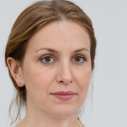 Joyful white young-adult female with medium  brown hair and green eyes