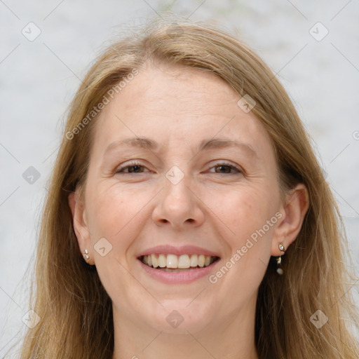 Joyful white adult female with long  brown hair and grey eyes