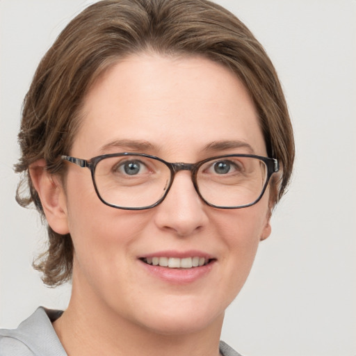 Joyful white adult female with medium  brown hair and grey eyes