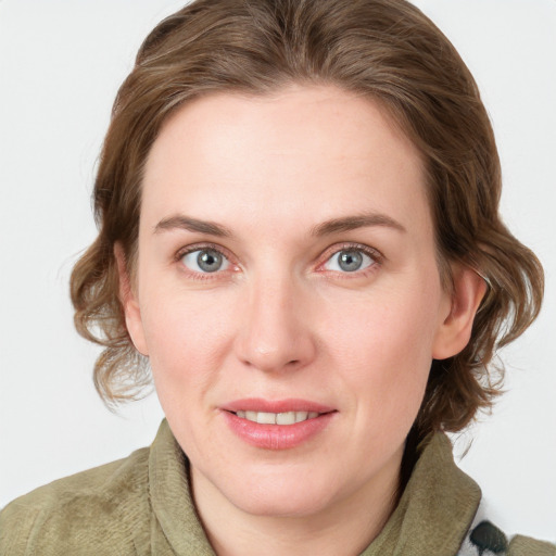 Joyful white young-adult female with medium  brown hair and blue eyes