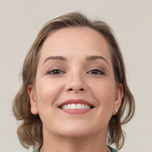 Joyful white young-adult female with medium  brown hair and grey eyes