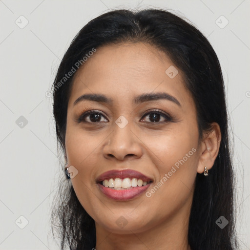 Joyful latino young-adult female with long  black hair and brown eyes