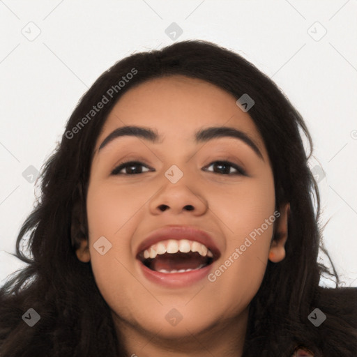 Joyful latino young-adult female with long  black hair and brown eyes