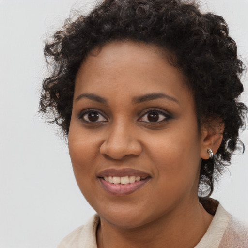 Joyful black young-adult female with medium  black hair and brown eyes
