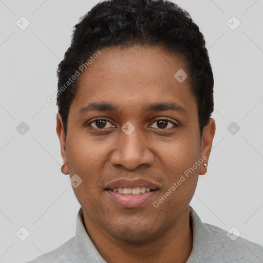 Joyful black young-adult male with short  black hair and brown eyes