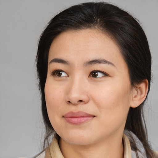 Joyful asian young-adult female with medium  brown hair and brown eyes