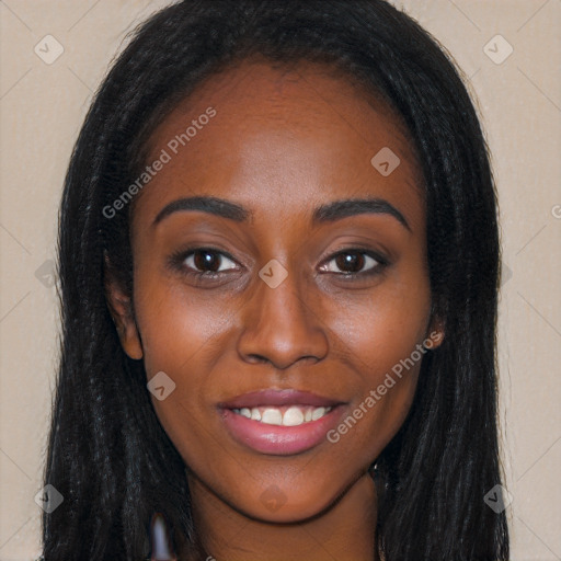 Joyful black young-adult female with long  brown hair and brown eyes