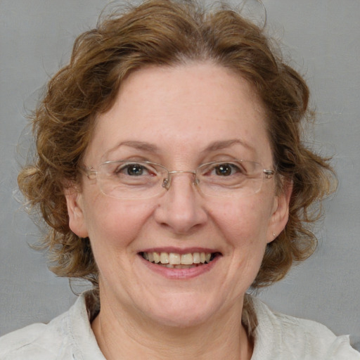 Joyful white middle-aged female with medium  brown hair and blue eyes