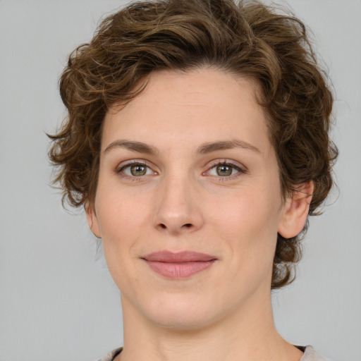 Joyful white young-adult female with medium  brown hair and green eyes