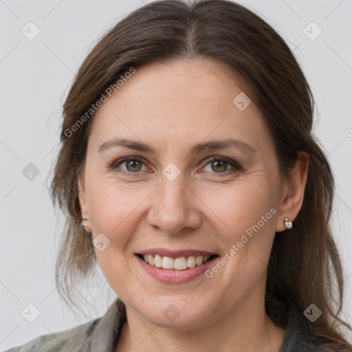 Joyful white adult female with medium  brown hair and grey eyes