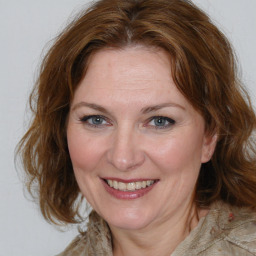 Joyful white adult female with medium  brown hair and brown eyes