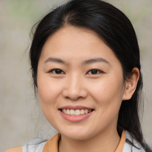 Joyful asian young-adult female with medium  brown hair and brown eyes
