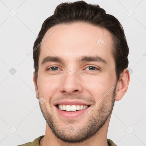 Joyful white young-adult male with short  brown hair and brown eyes