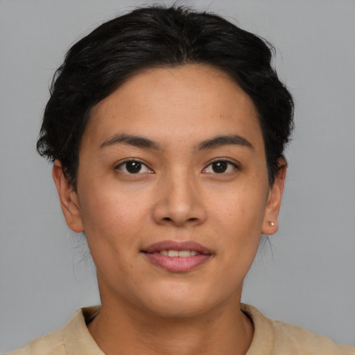 Joyful asian young-adult female with short  brown hair and brown eyes