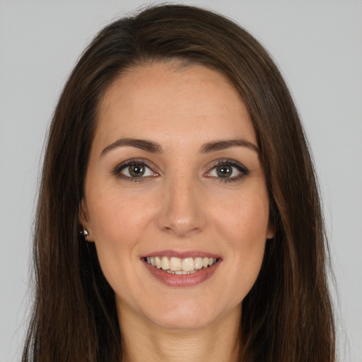 Joyful white young-adult female with long  brown hair and brown eyes