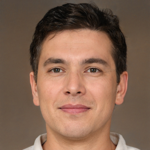 Joyful white adult male with short  brown hair and brown eyes